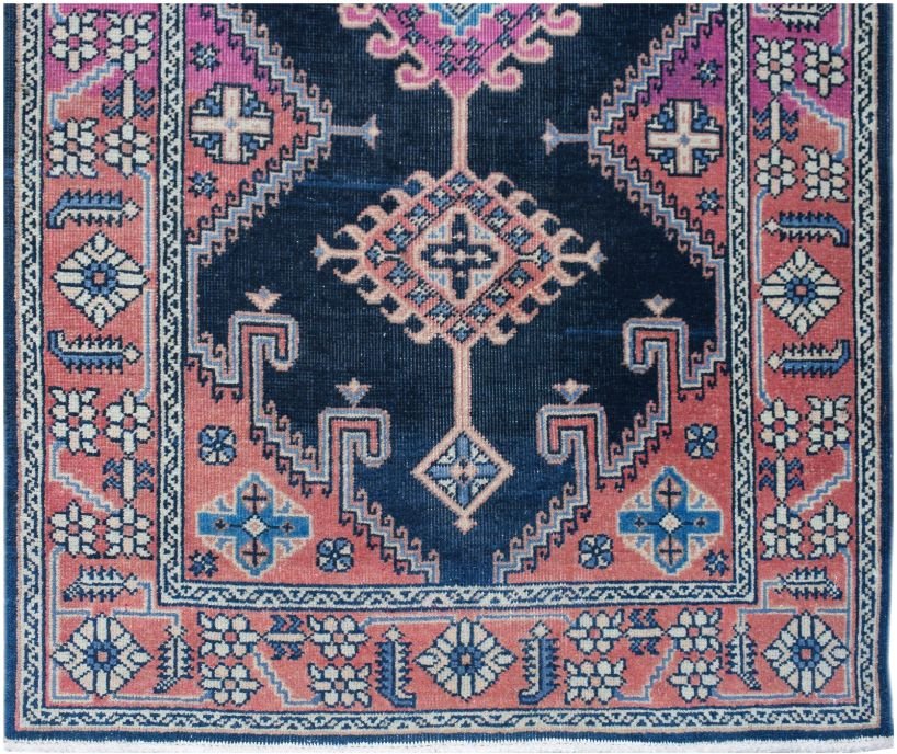 A vintage Persian Hamadan runner featuring a dark blue field with pink and blue geometric motifs.
