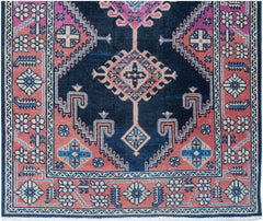 A vintage Persian Hamadan runner featuring a dark blue field with pink and blue geometric motifs.