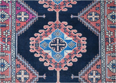 A vintage Persian Hamadan runner featuring geometric medallions in blue and pink on a dark field.