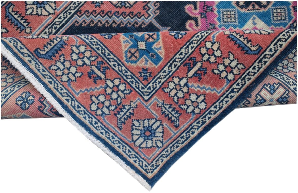 A vintage Persian Hamadan runner featuring a geometric floral pattern in red, blue, and cream.