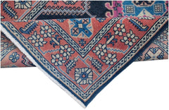 A vintage Persian Hamadan runner featuring a geometric floral pattern in red, blue, and cream.