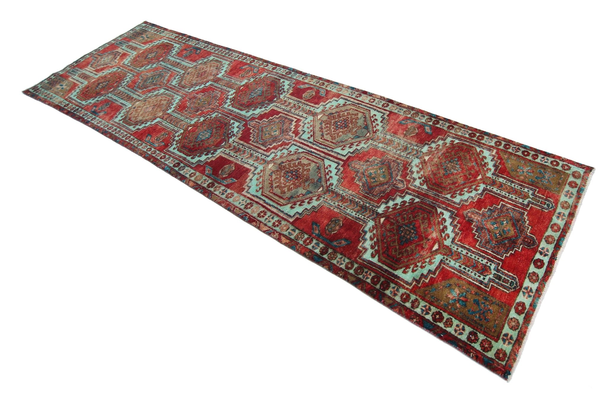 A vintage Persian Hamadan runner featuring a geometric pattern in red, blue, and beige tones.
