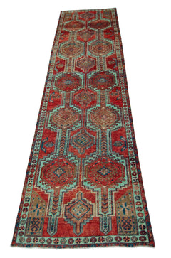 A vintage Persian Hamadan runner featuring geometric medallions in red and teal wool.