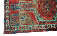 A vintage Persian Hamadan runner featuring a geometric pattern in red, teal, and brown wool.