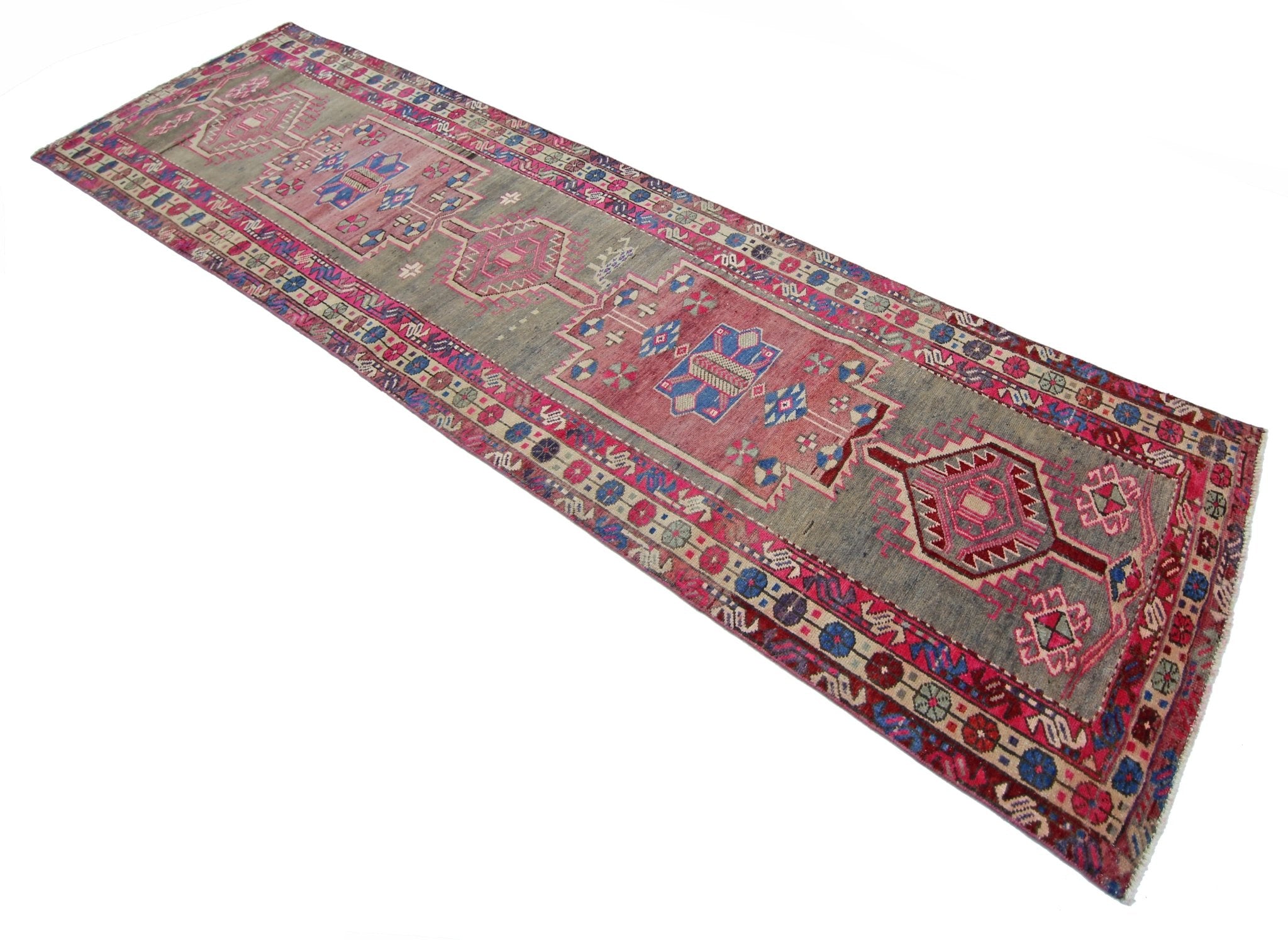 A vintage Persian Hamadan runner featuring geometric medallions in pink and blue on a grey field.