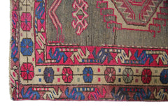 A vintage Persian Hamadan runner featuring a geometric pattern in vibrant pink, blue, and grey.