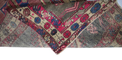 A vintage Persian Hamadan runner featuring a geometric floral pattern in pink, blue, and cream.