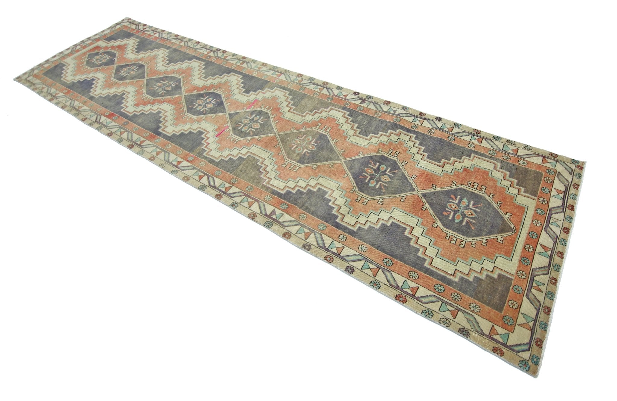 A vintage Persian Hamadan runner featuring a geometric pattern in muted orange and grey tones.