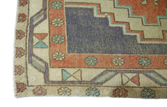 A vintage Persian Hamadan runner featuring a geometric blue center and floral border patterns.
