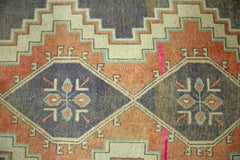 A vintage Persian Hamadan runner featuring geometric diamond motifs in blue, orange, and cream.