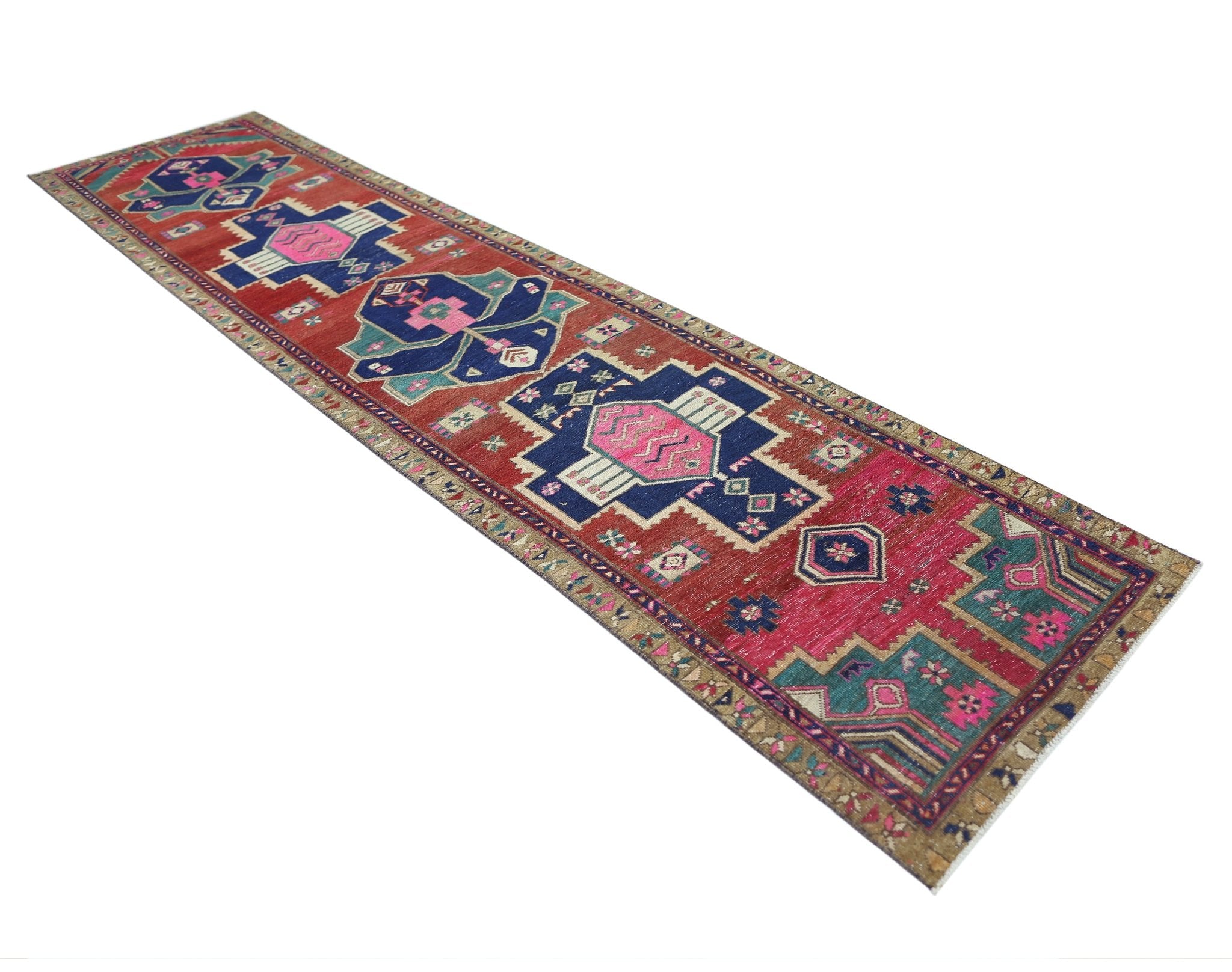 A vintage Persian Hamadan runner rug featuring geometric blue and pink medallions on a red field.