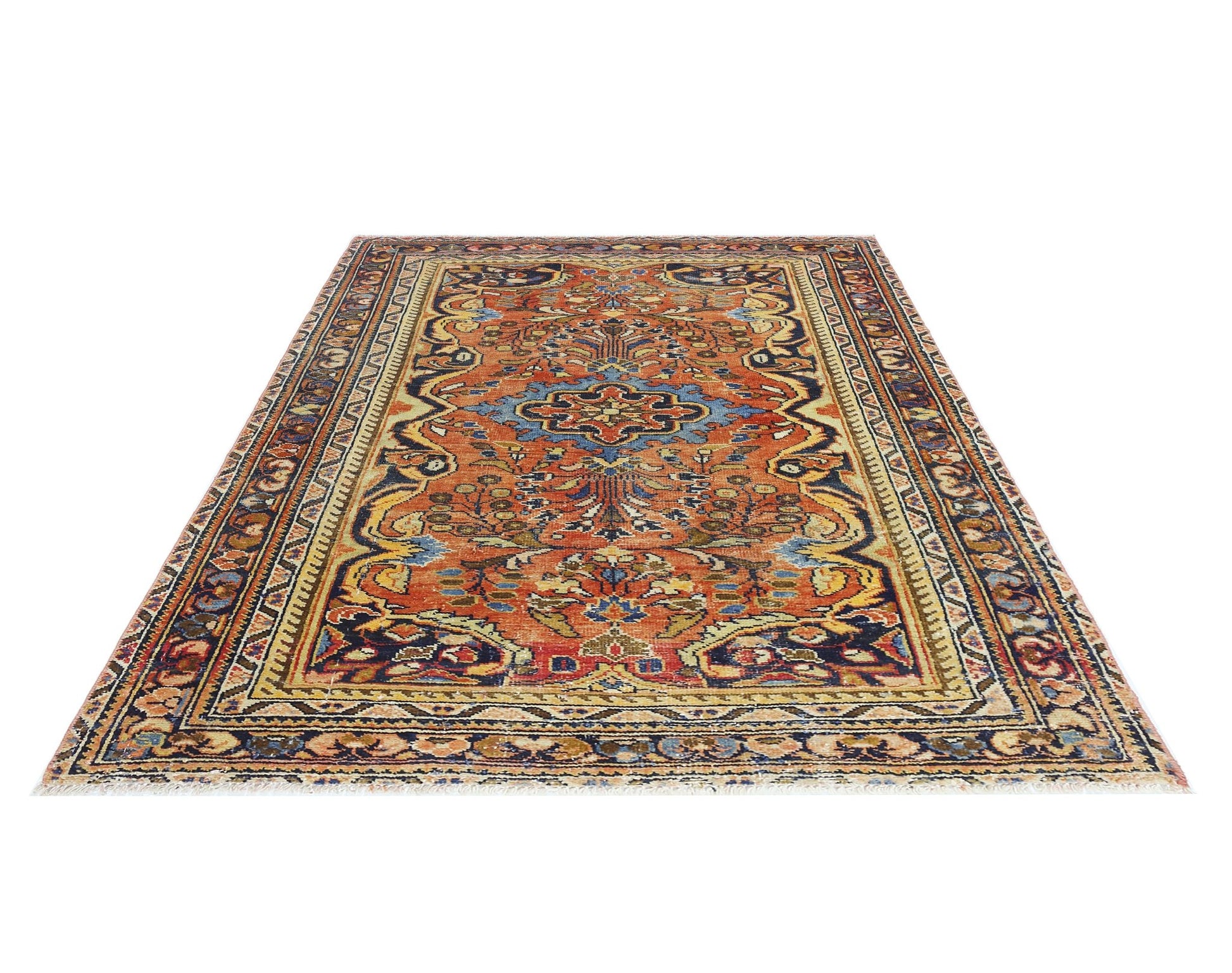 A vintage Persian Heriz rug featuring a central blue medallion on a rust-colored field.
