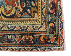 A corner view of a vintage Persian Heriz rug featuring intricate geometric patterns in wool.
