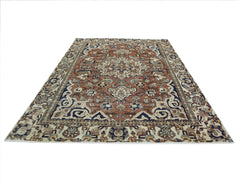 A vintage Persian Heriz rug featuring a traditional geometric medallion pattern in rust and blue.