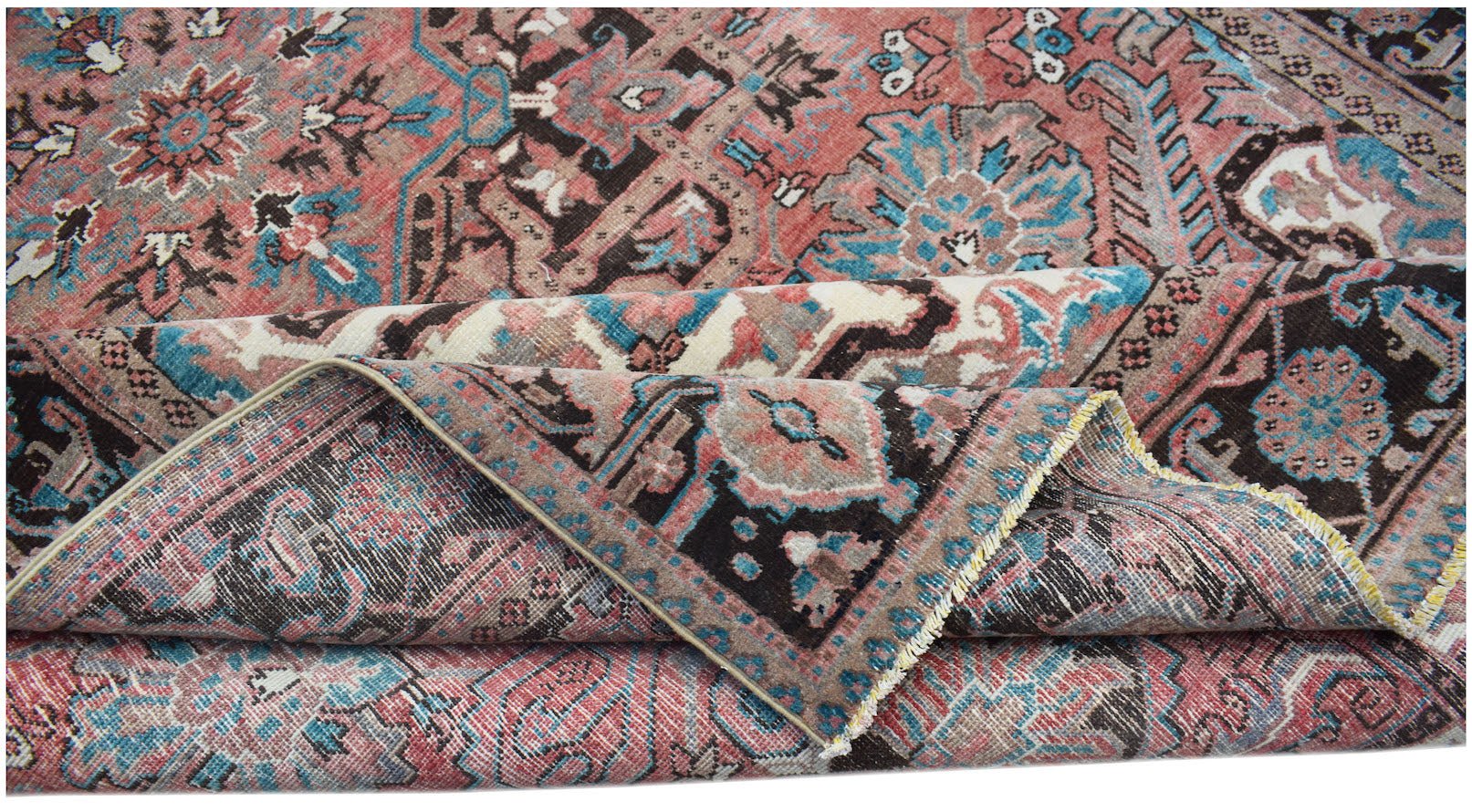A vintage handwoven Persian Heriz rug featuring a geometric floral pattern in red, blue, and brown.