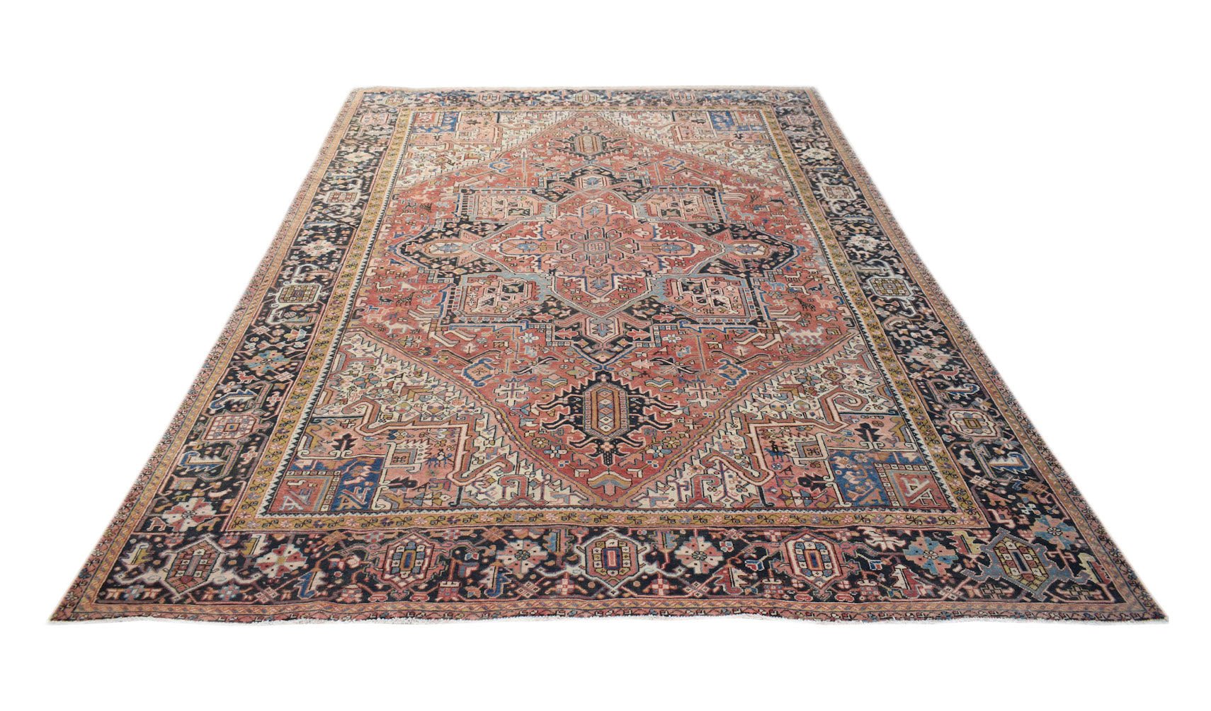 A vintage handwoven Persian Heriz rug featuring a geometric medallion on a terracotta field.