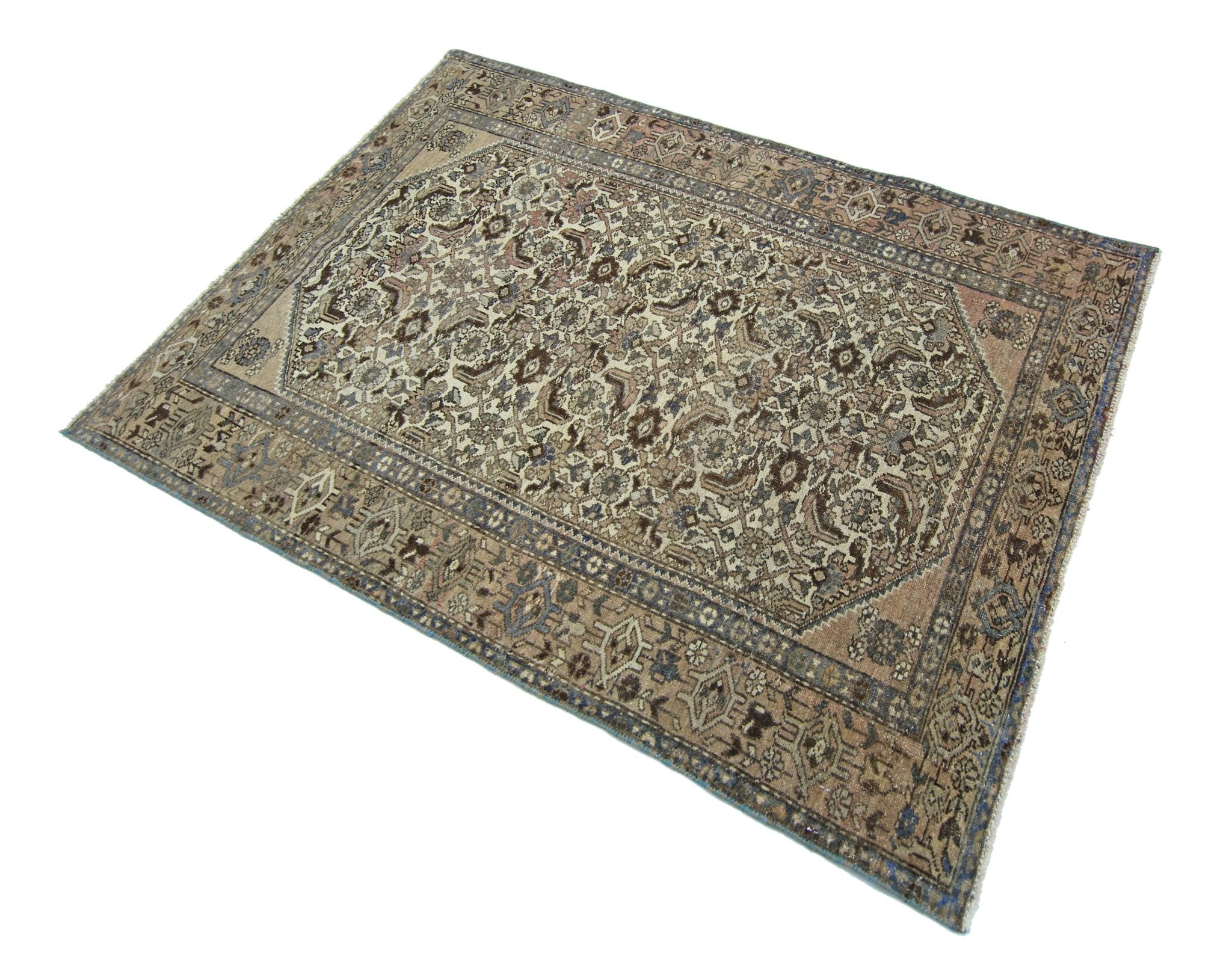 A vintage handmade Persian rug featuring an intricate floral pattern in muted earth tones.