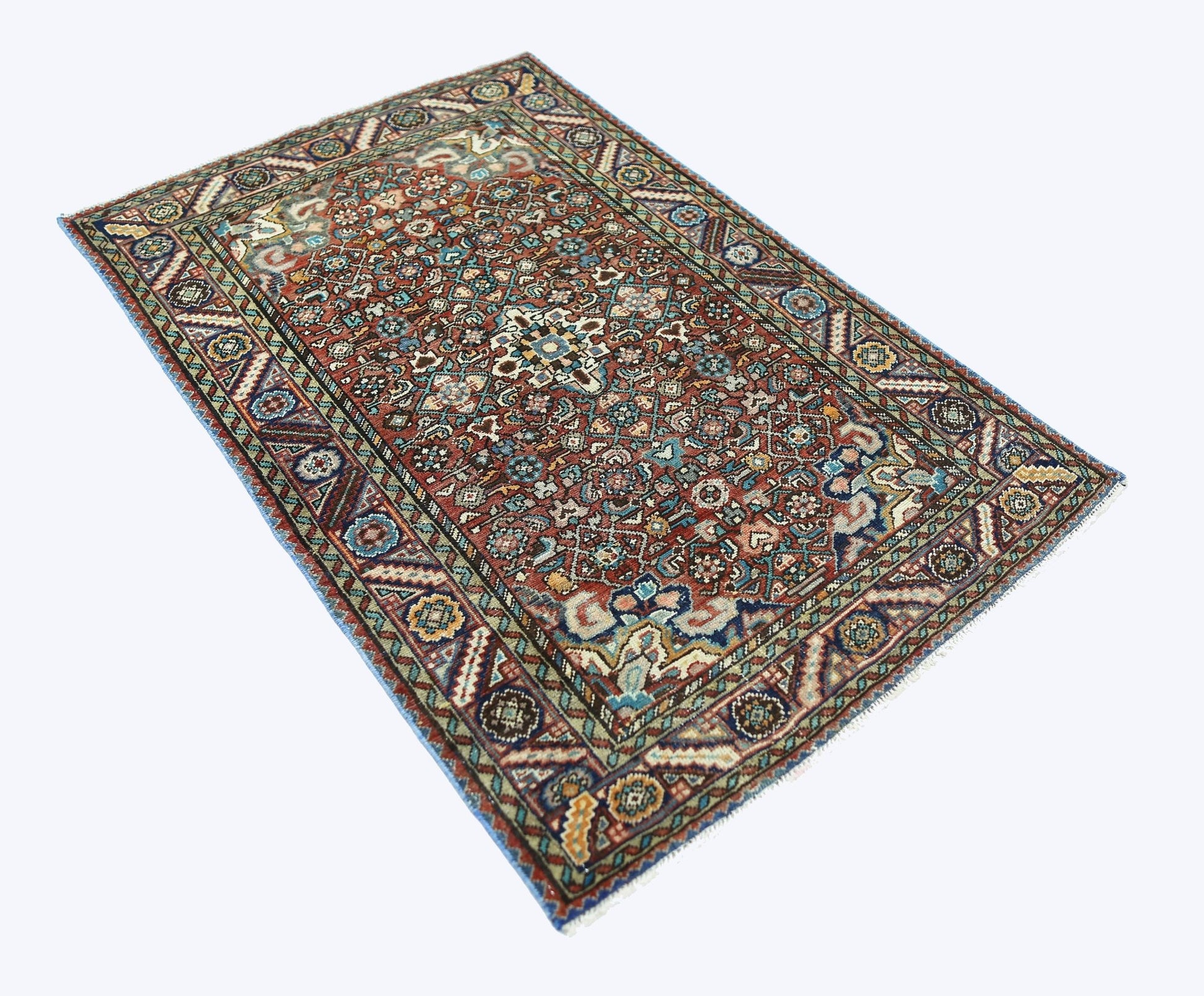 A rectangular vintage Persian rug featuring an intricate floral pattern in red, blue, and cream.