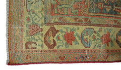 A close-up of a vintage handmade Persian rug featuring intricate floral patterns in muted tones.
