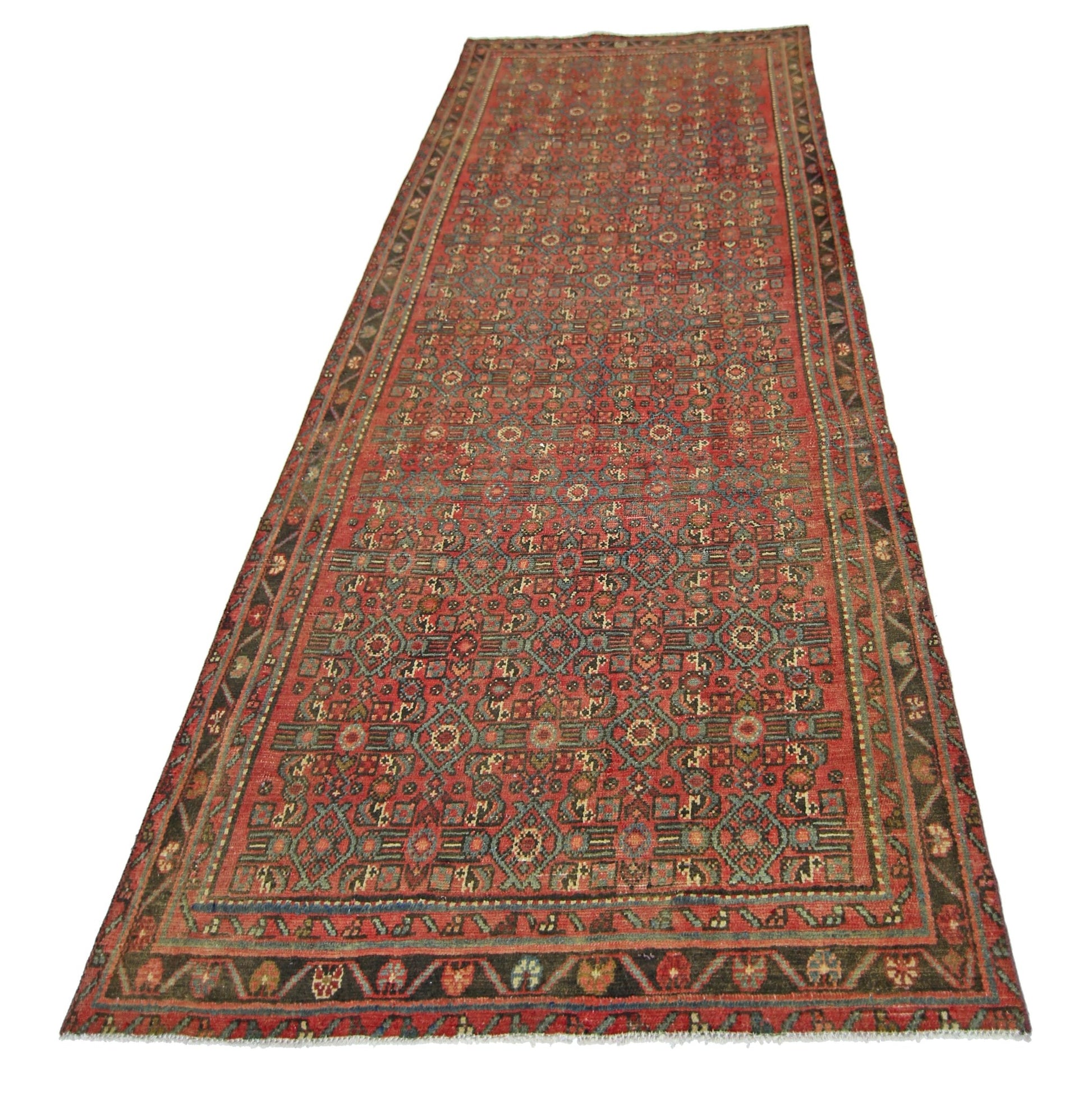 A vintage handmade Persian runner rug featuring a geometric pattern in red, blue, and green tones.
