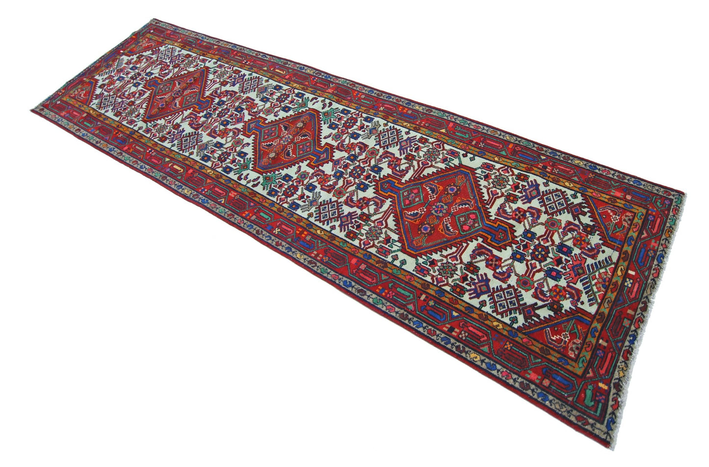 A vintage Persian Hamadan runner featuring a geometric pattern with three central medallions.