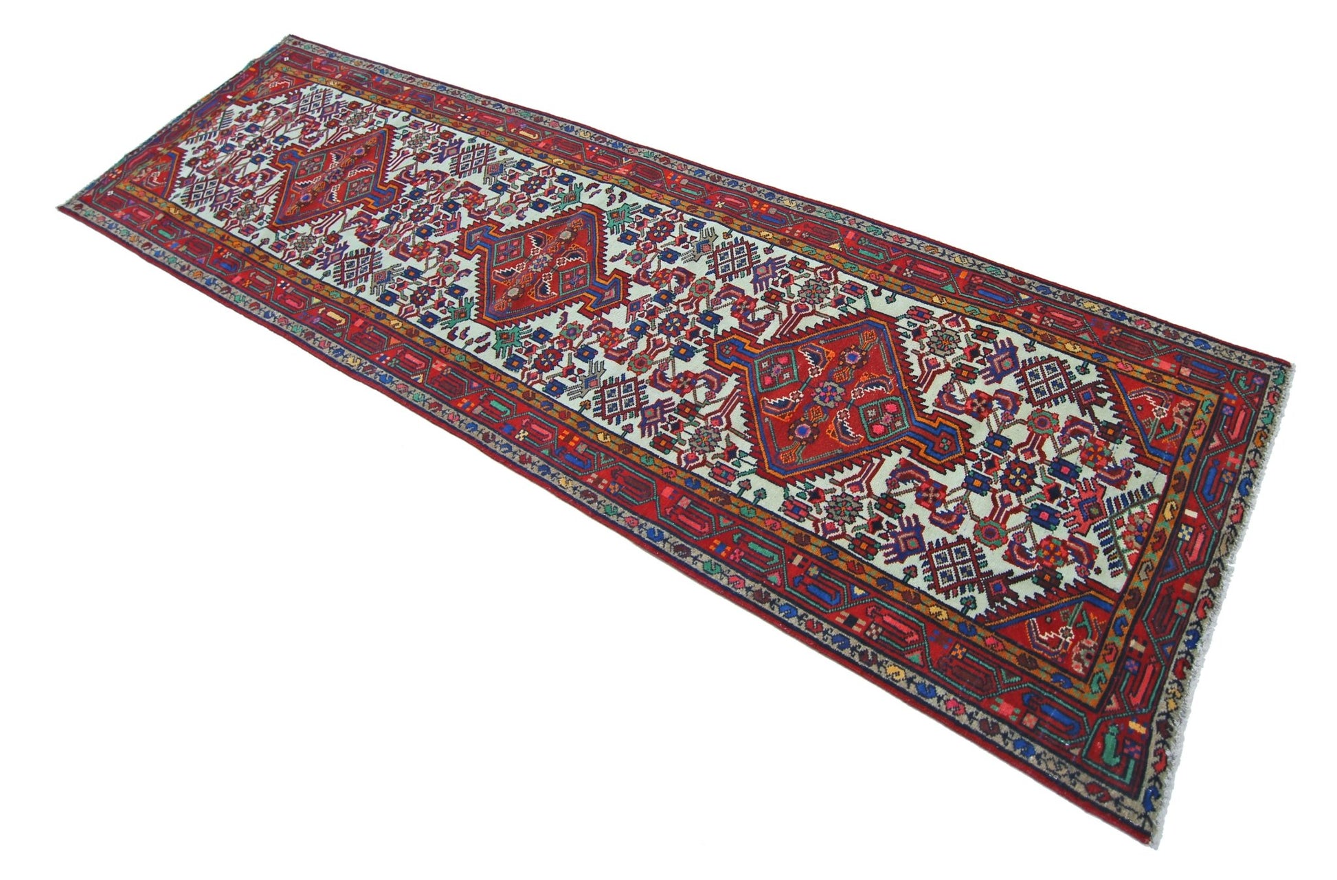 A vintage Persian Hamadan runner featuring a geometric pattern with three central medallions.