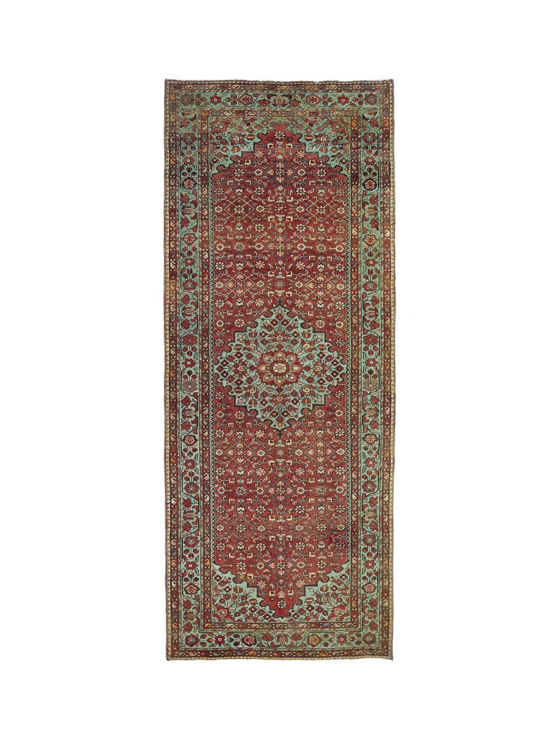 A vintage Persian Hossainabad runner featuring a red field with a central teal medallion.