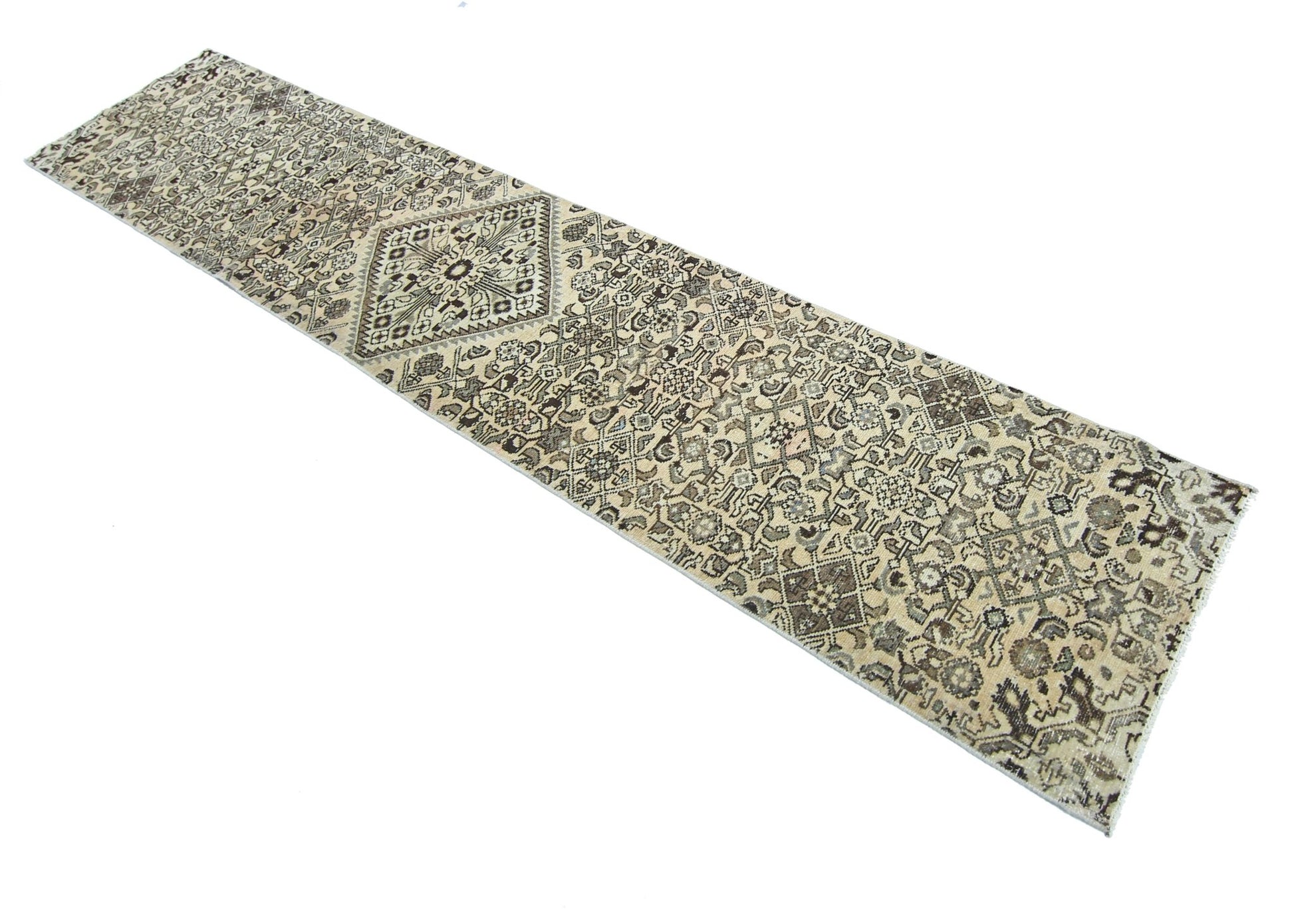 A vintage Persian Hamadan runner rug featuring intricate geometric patterns in neutral tones.