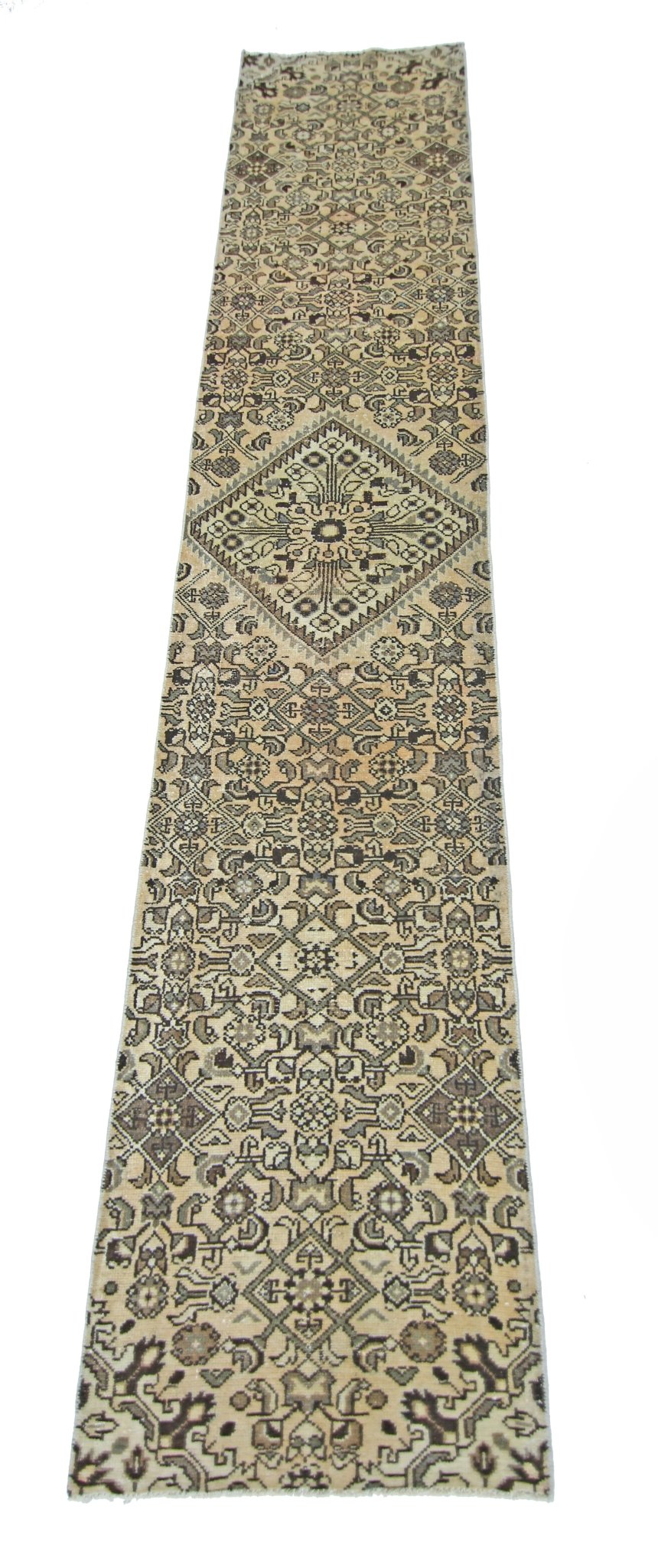 A vintage Persian Hamadan runner rug featuring intricate geometric patterns in neutral tones.