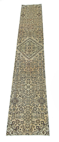 A vintage Persian Hamadan runner rug featuring intricate geometric patterns in neutral tones.
