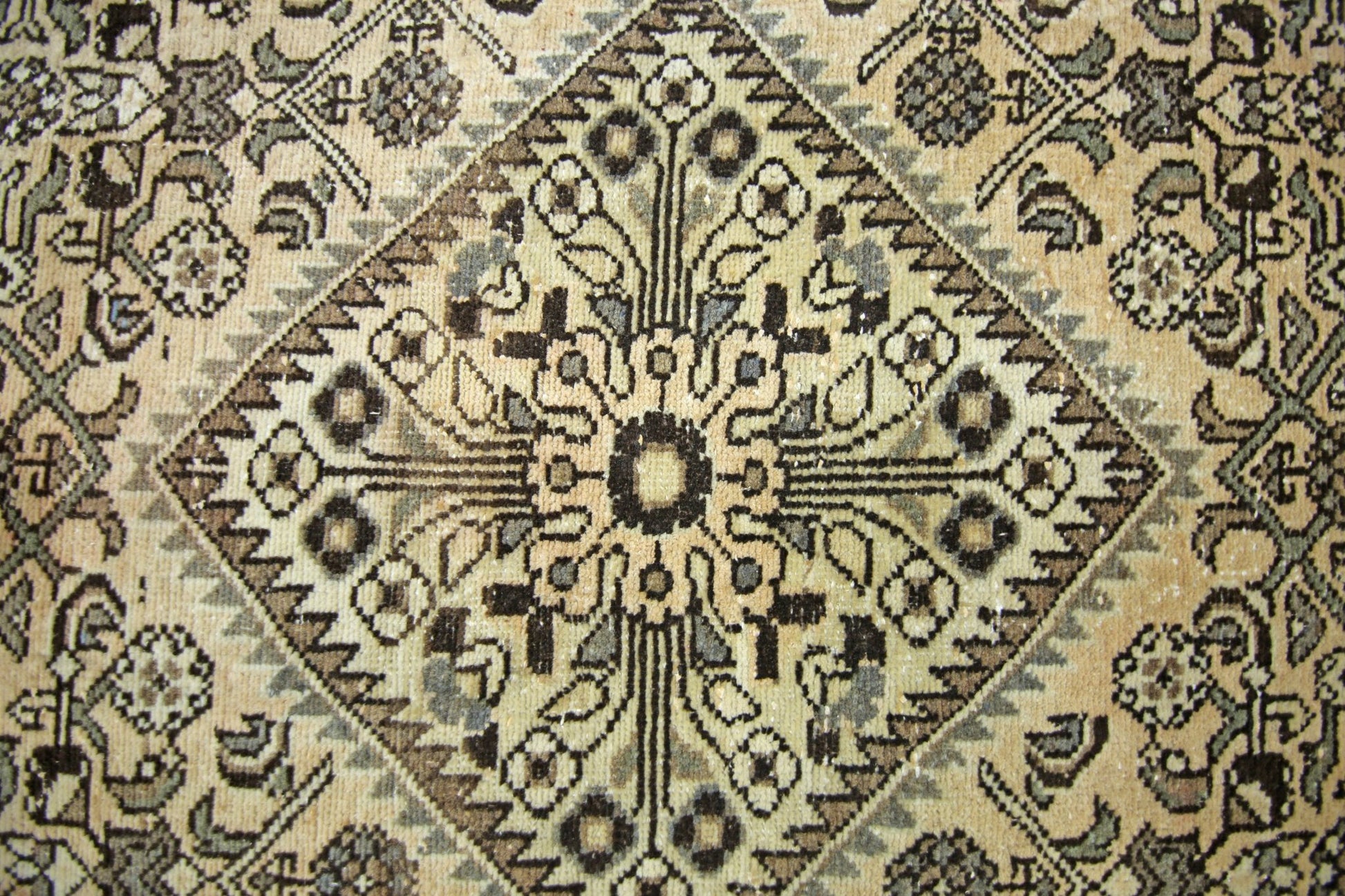 A vintage Persian Hamadan runner featuring a geometric diamond medallion in neutral tones.