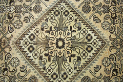 A vintage Persian Hamadan runner featuring a geometric diamond medallion in neutral tones.