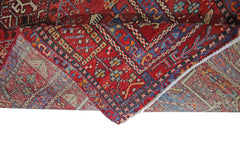 A vintage Persian Karaja runner featuring a geometric pattern in red, blue, and cream wool.