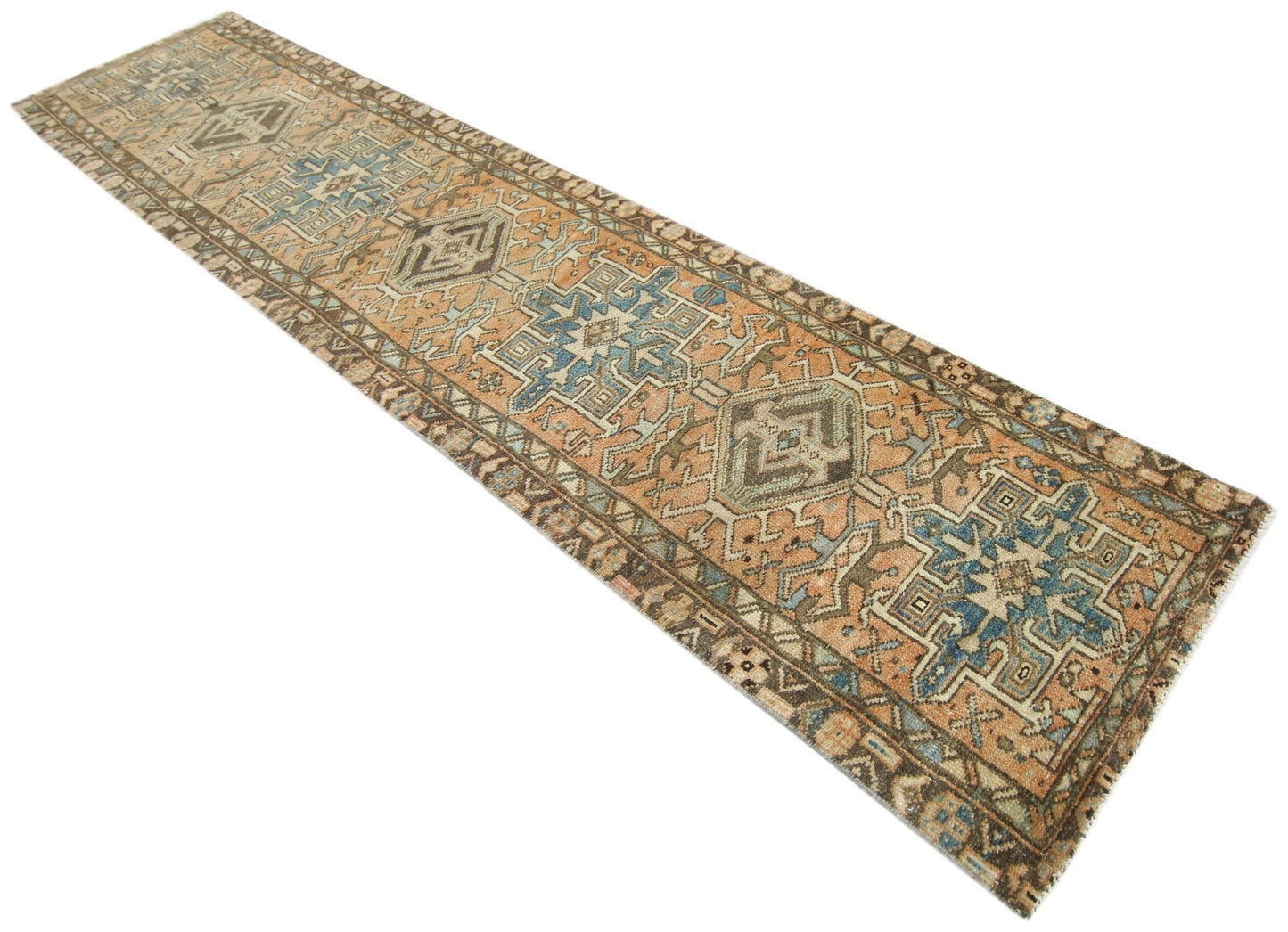 A vintage Persian Karaja runner featuring geometric medallions in blue and orange tones.