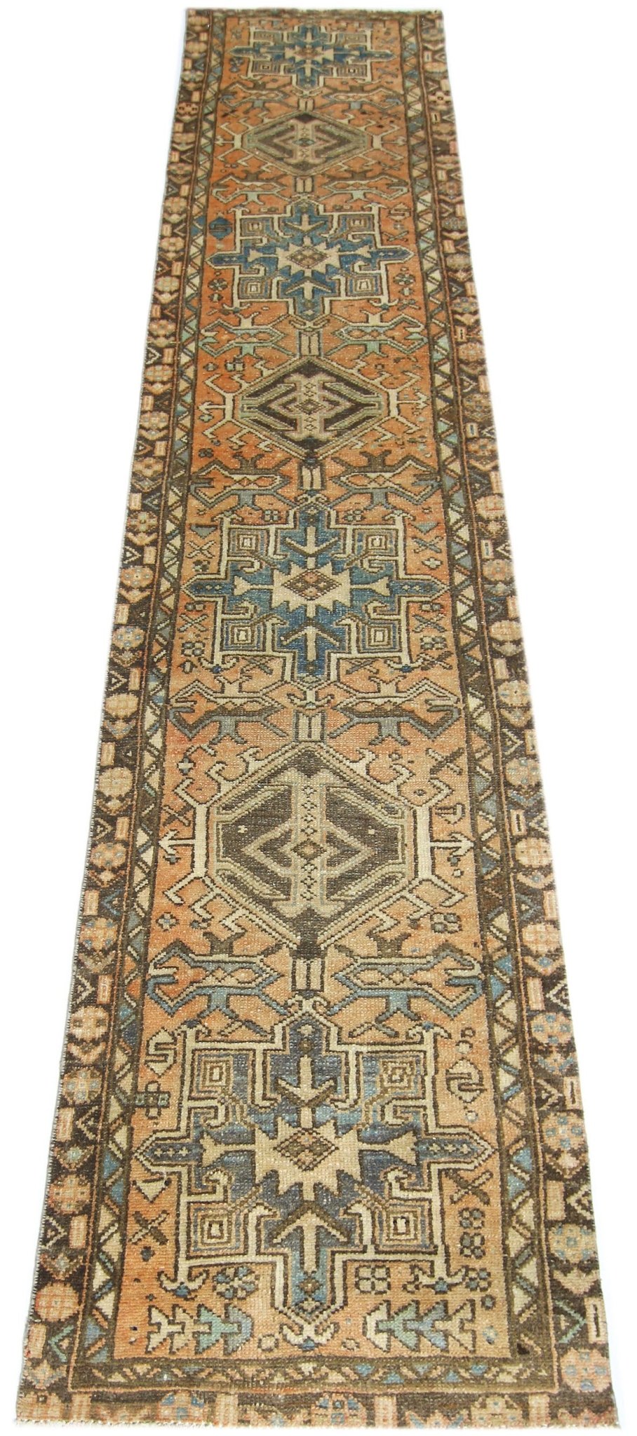 A vintage Persian Karaja runner rug featuring geometric medallions in blue and orange tones.