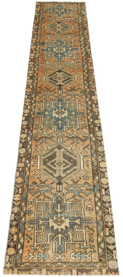A vintage Persian Karaja runner rug featuring geometric medallions in blue and orange tones.
