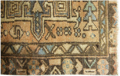 A close-up of a vintage Persian Karaja runner featuring geometric patterns in wool on cotton.