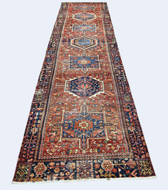 A vintage Persian Karaja runner featuring geometric medallions in red and blue wool.