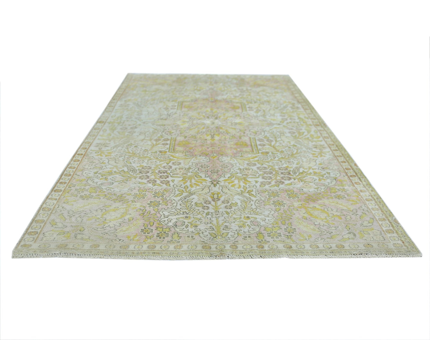 A vintage Persian Kashan rug featuring a faded floral pattern in soft yellow and pink tones.