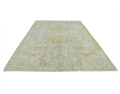 A vintage Persian Kashan rug featuring a faded floral pattern in soft yellow and pink tones.
