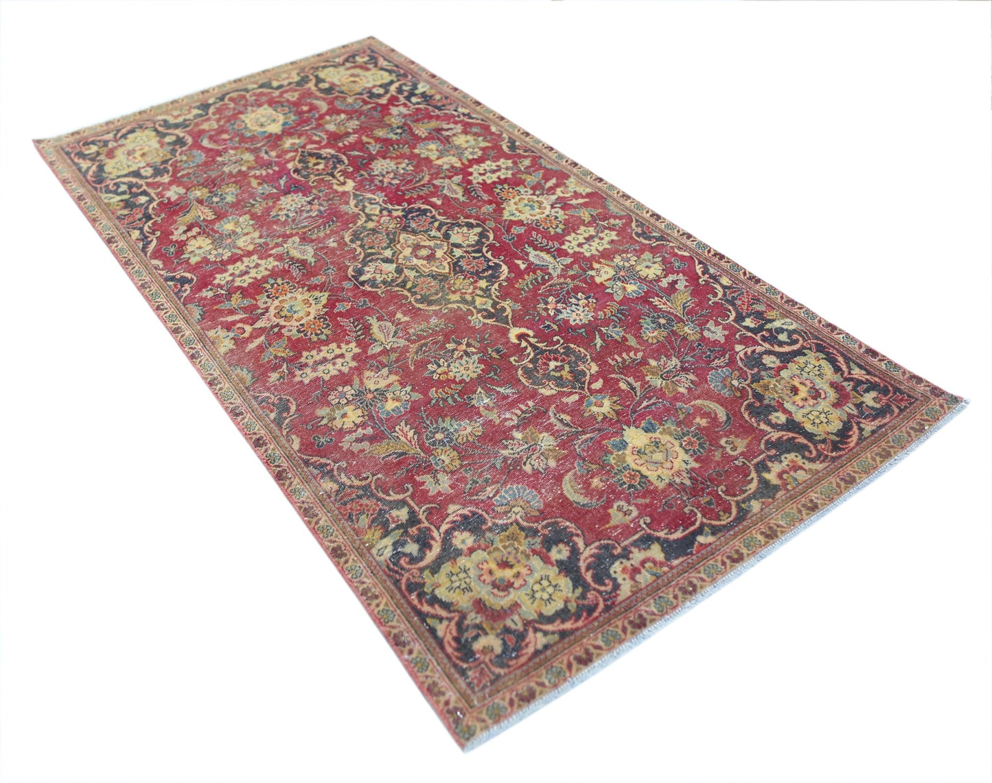 A vintage Persian Kashan rug featuring a traditional floral pattern in red, blue, and cream tones.