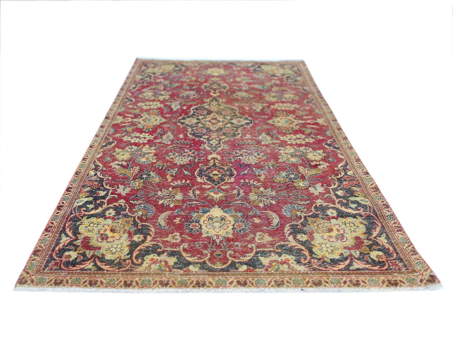 A vintage Persian Kashan rug featuring a traditional floral pattern in red, blue, and cream tones.