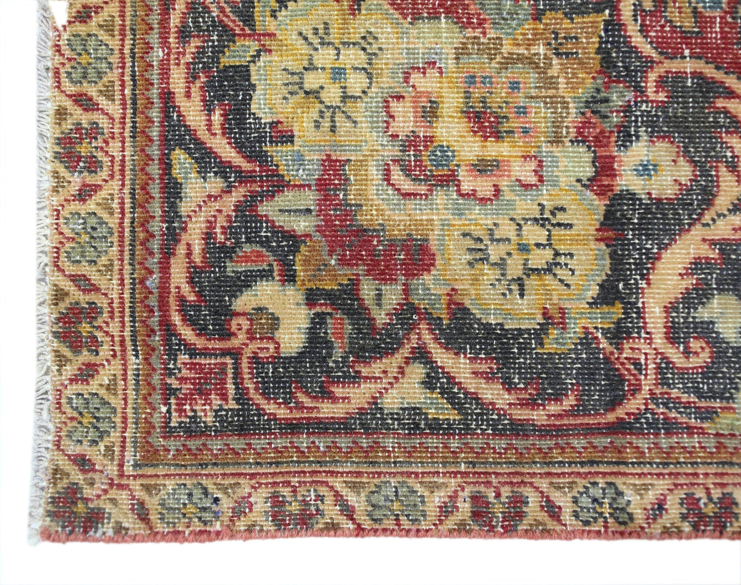 A vintage Persian Kashan rug featuring intricate floral patterns in red, gold, and black.
