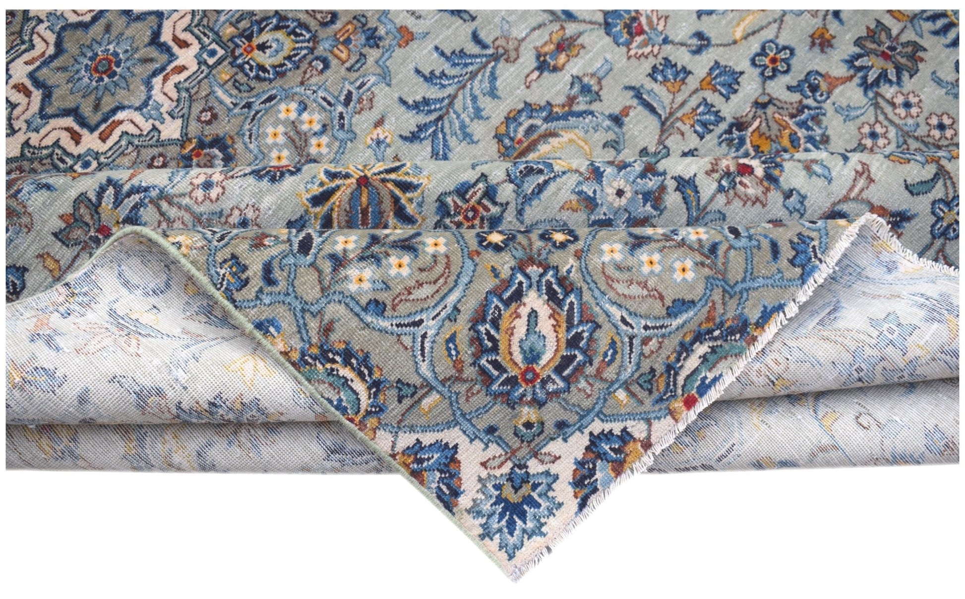 A vintage handwoven Persian Kashan rug featuring intricate blue and cream floral patterns.
