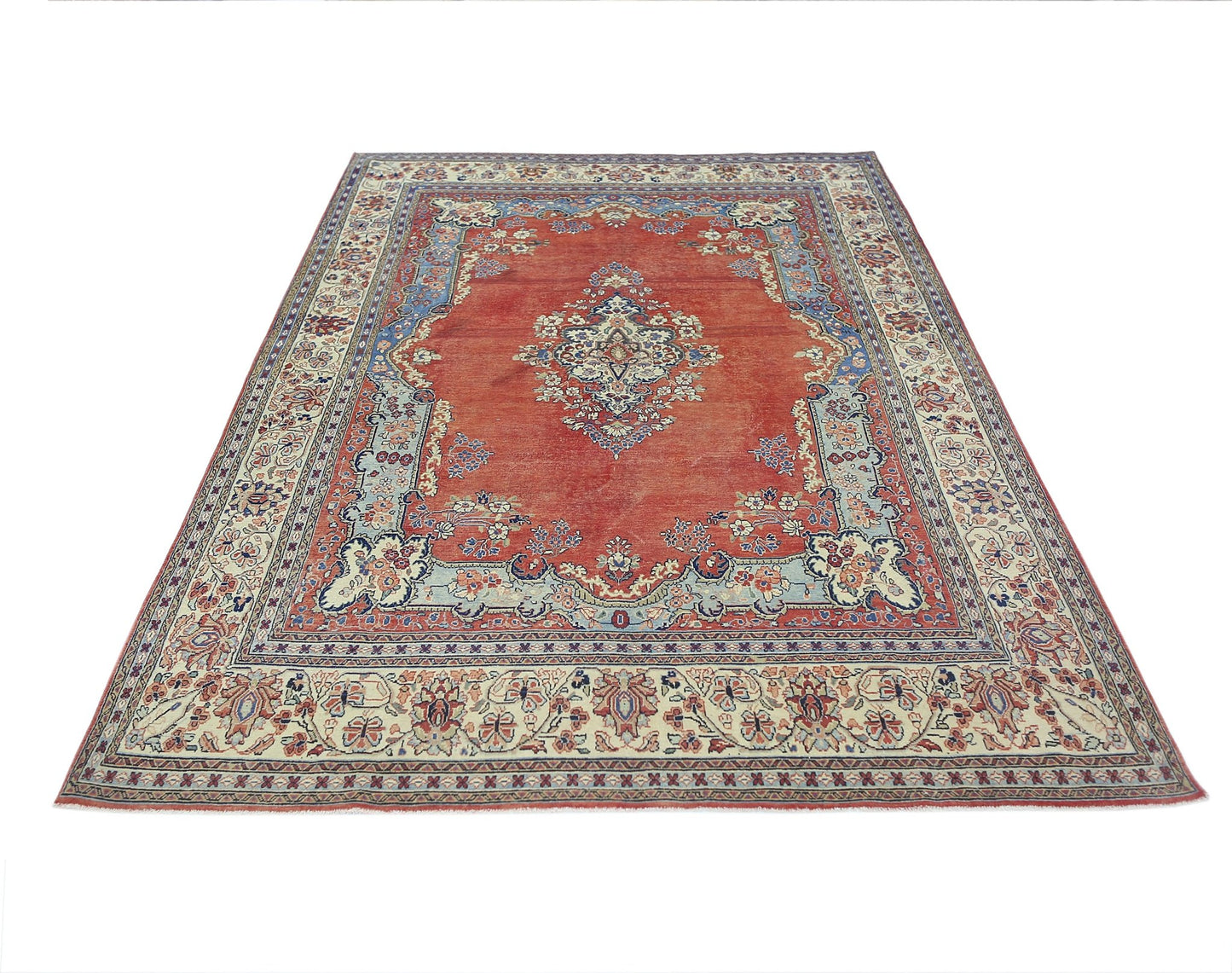 A vintage Persian Tabriz rug featuring a central medallion on a red field with floral borders.