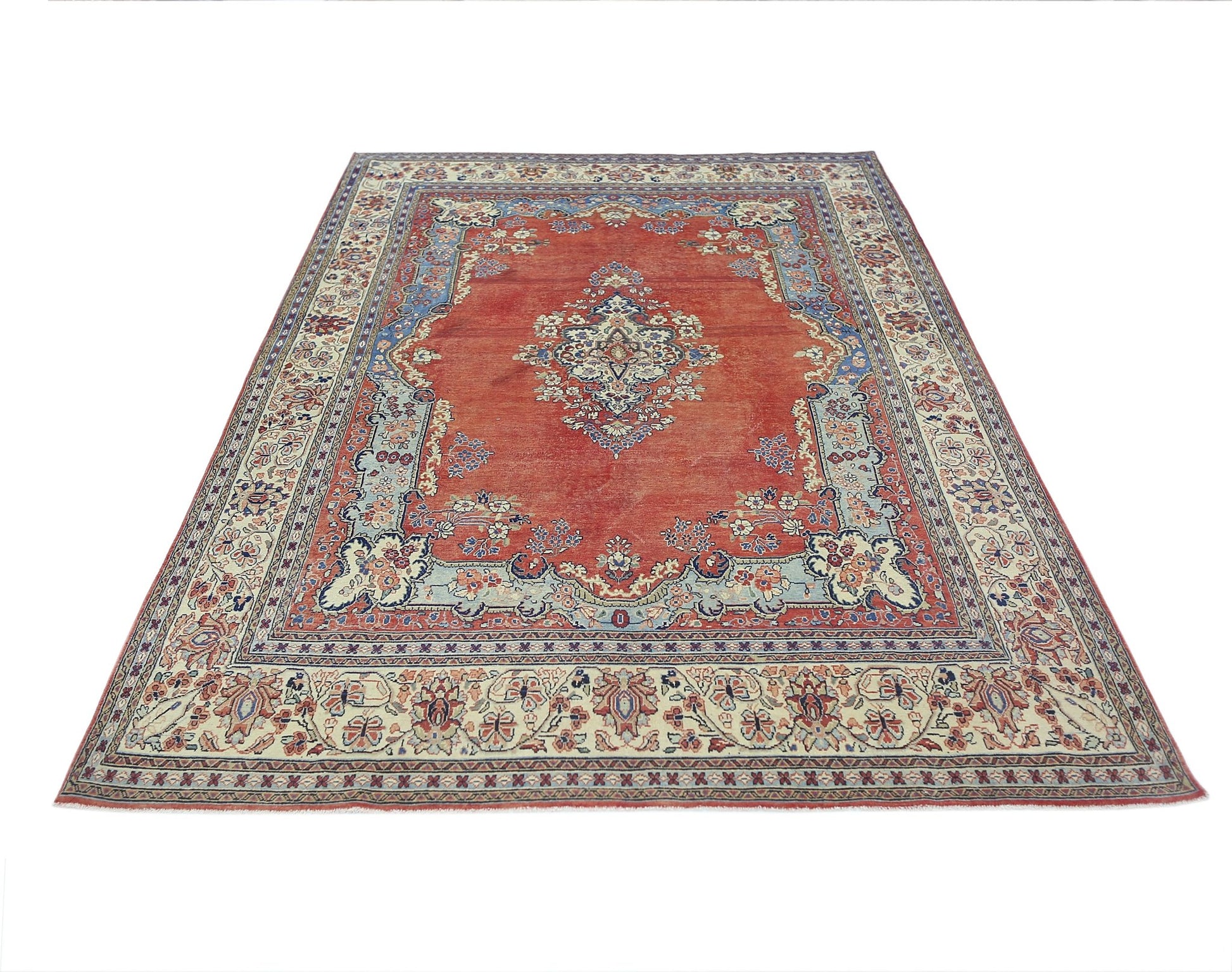 A vintage Persian Tabriz rug featuring a central medallion on a red field with floral borders.