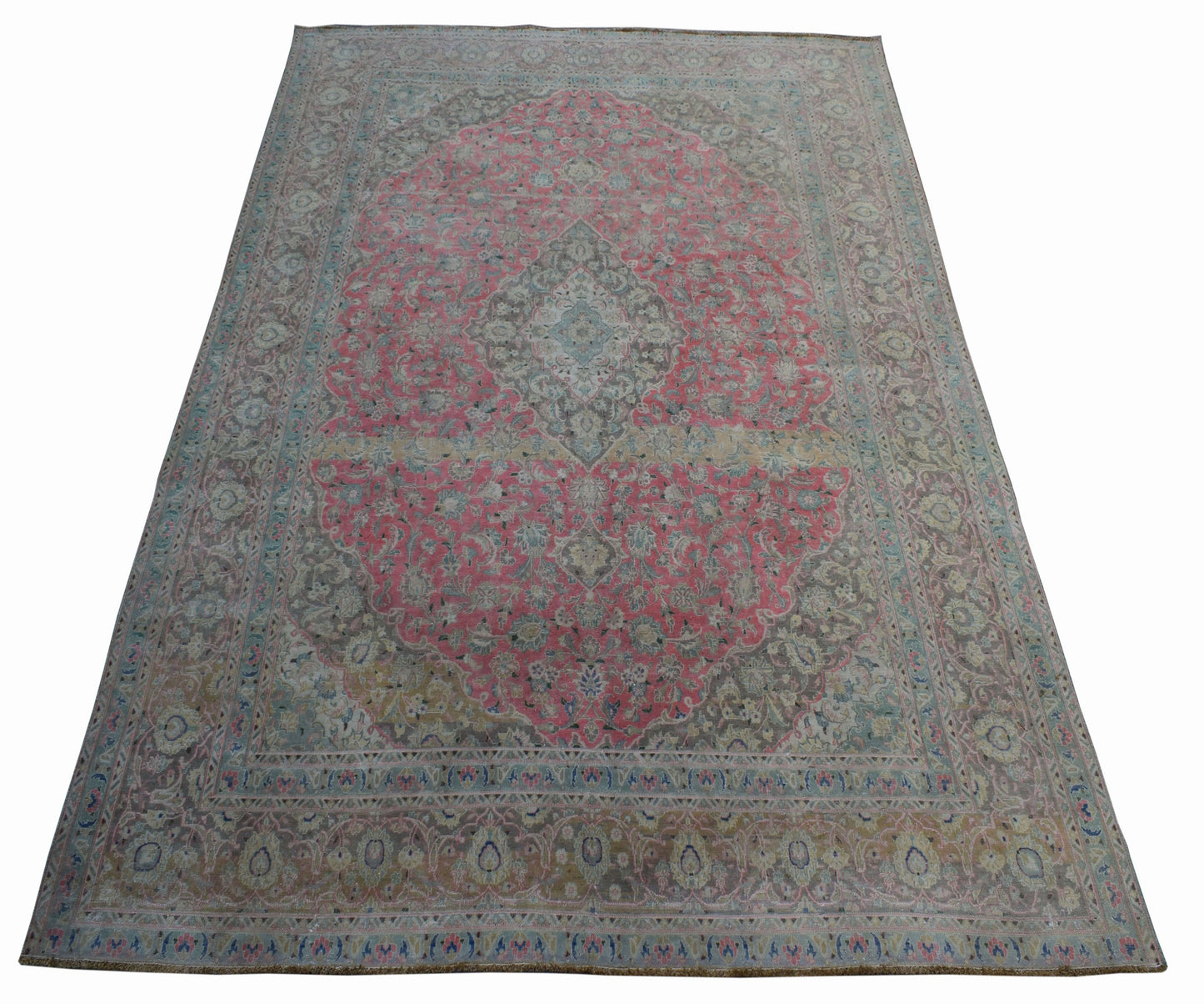 A vintage handwoven Persian Kashan rug featuring a central floral medallion in pink and grey tones.