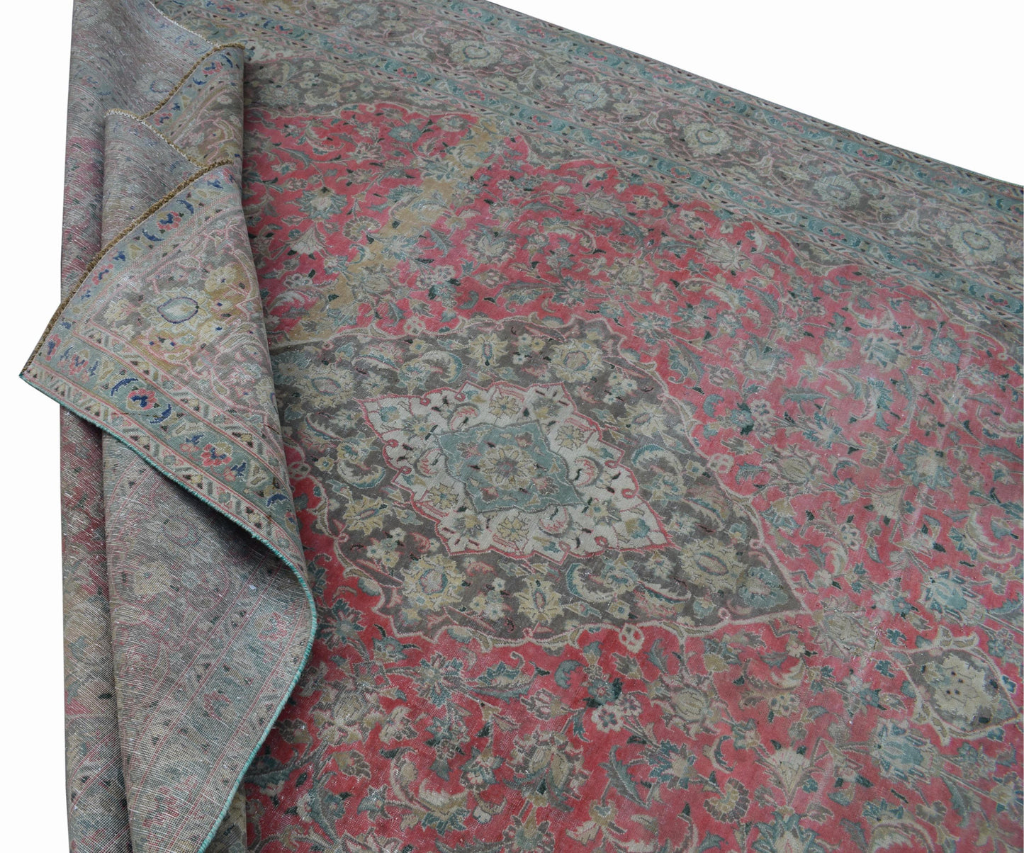 A vintage Persian Kashan rug featuring a faded floral pattern in pink, grey, and blue tones.