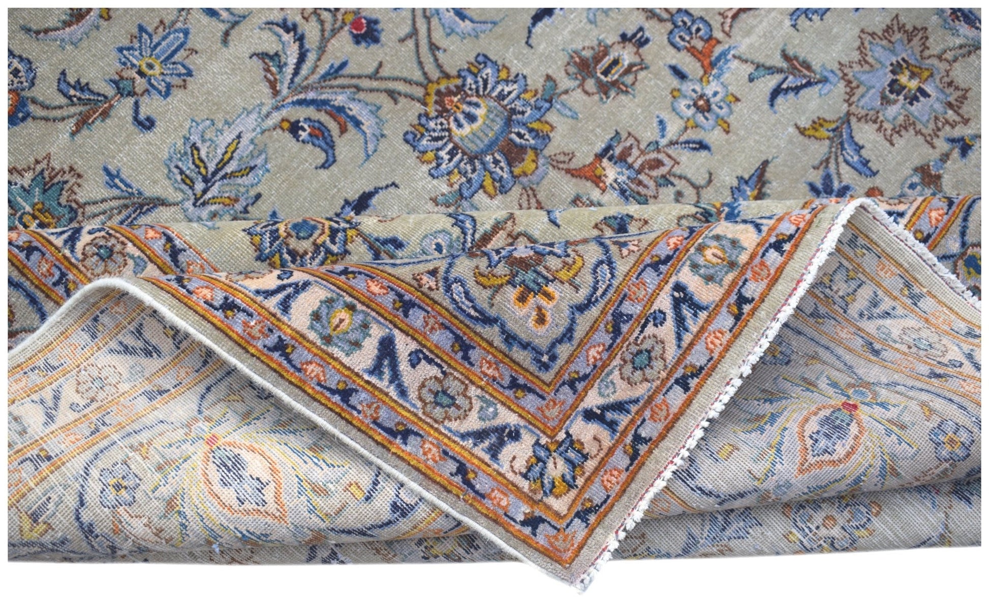 A vintage Persian Kashan rug featuring intricate floral patterns in blue, orange, and beige tones.