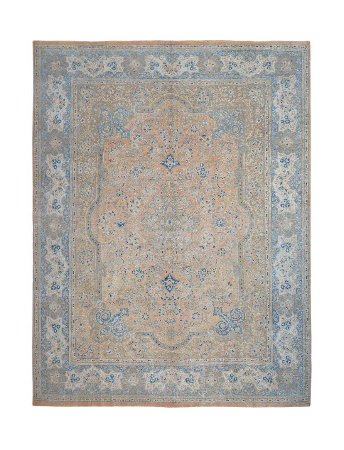 A vintage Persian Kashan rug featuring an intricate floral pattern in soft blue and peach tones.